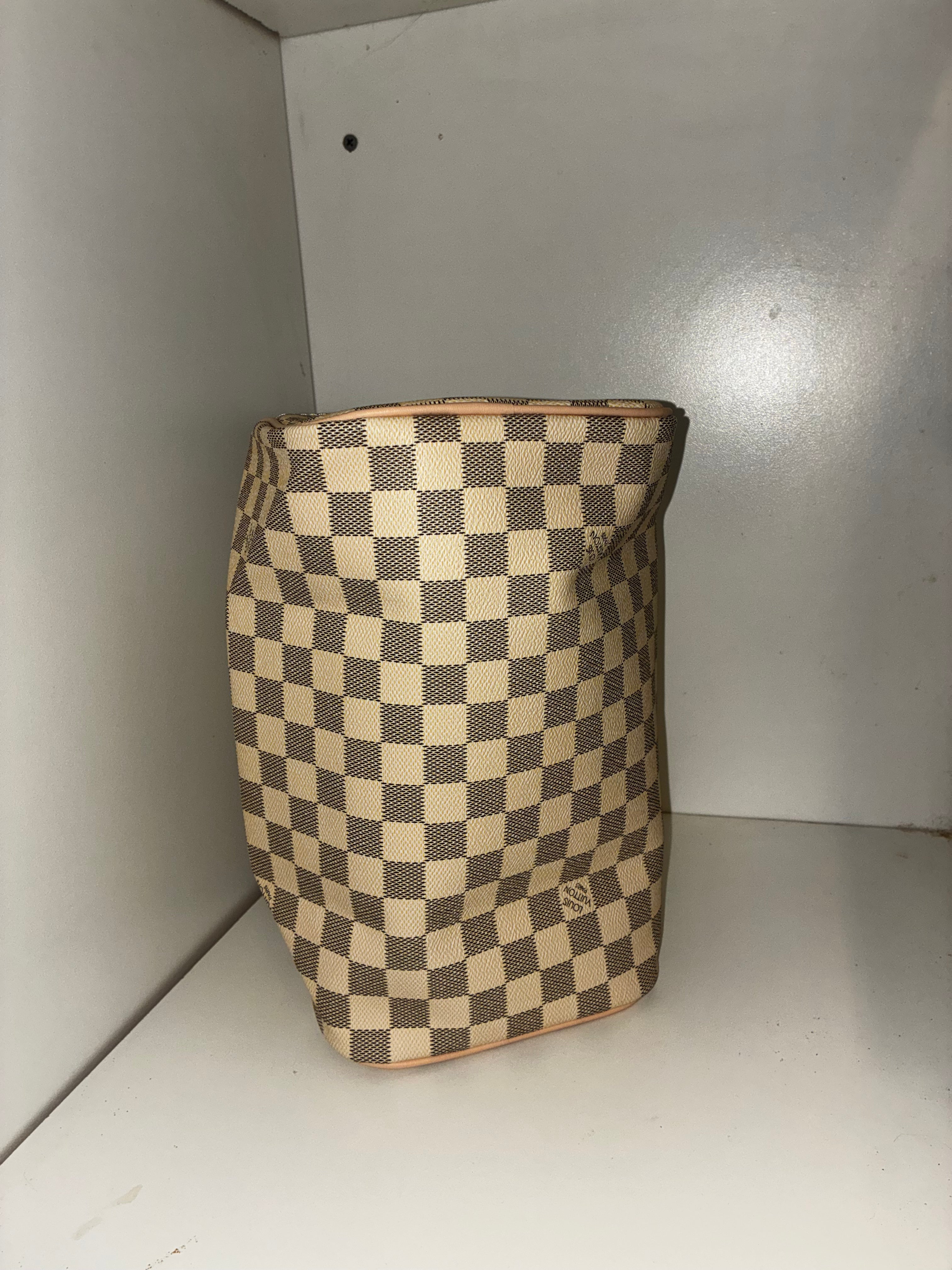 LV Toiletry Dopp Kit in the Damier Azur canvas pattern.